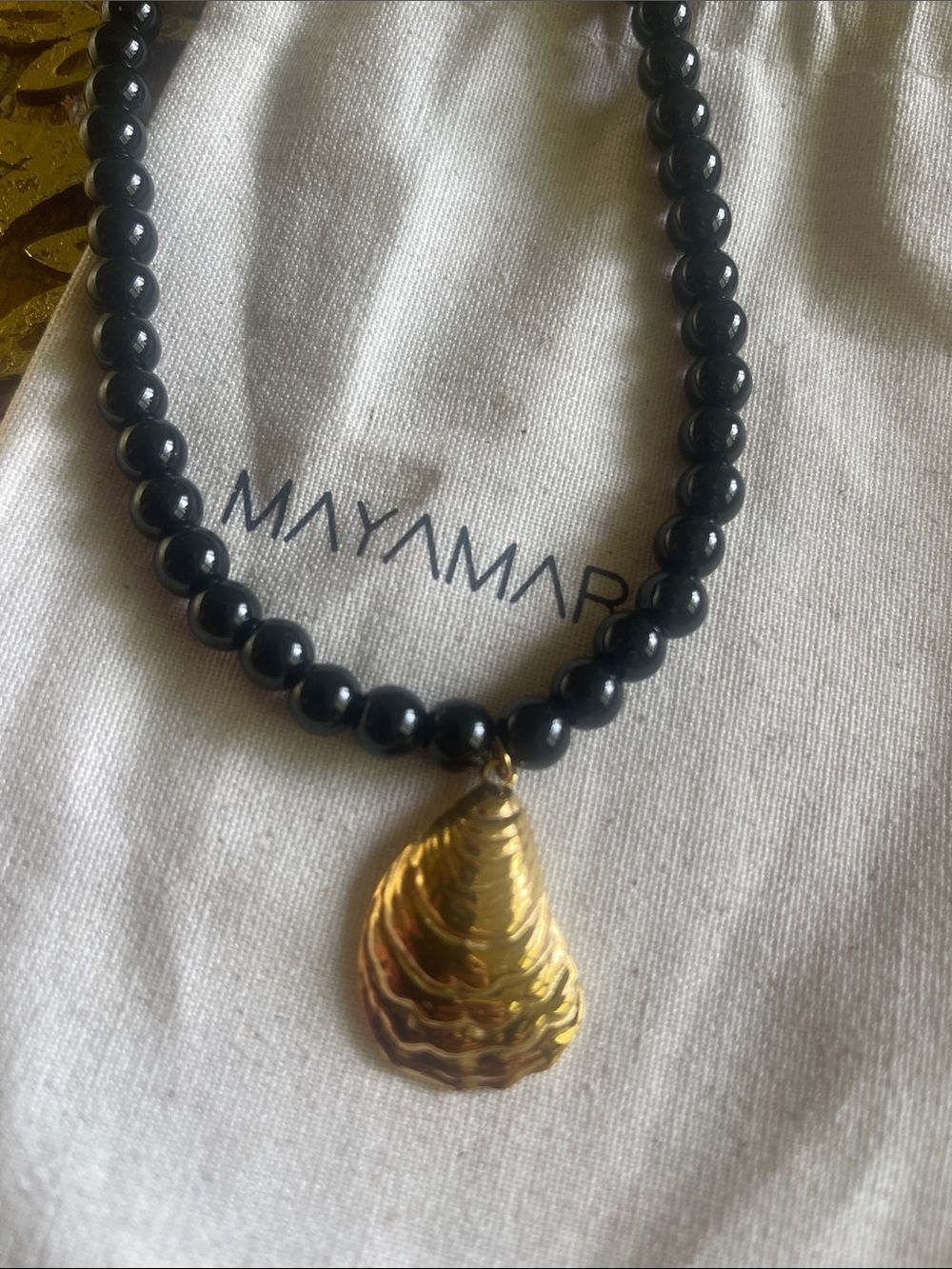 Gold Shell Pendant on Black Beaded Necklace